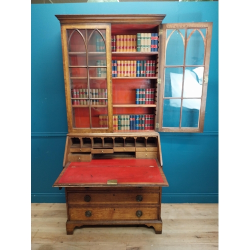 397 - Georgian oak bureau bookcase with fitted red velvet interior on bracket feet above two glazed doors.... 