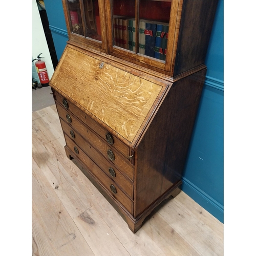 397 - Georgian oak bureau bookcase with fitted red velvet interior on bracket feet above two glazed doors.... 