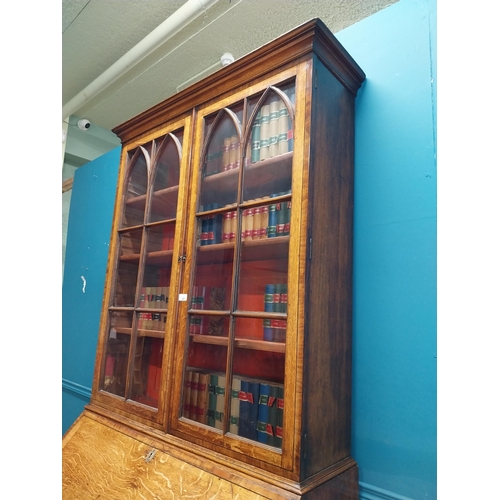 397 - Georgian oak bureau bookcase with fitted red velvet interior on bracket feet above two glazed doors.... 