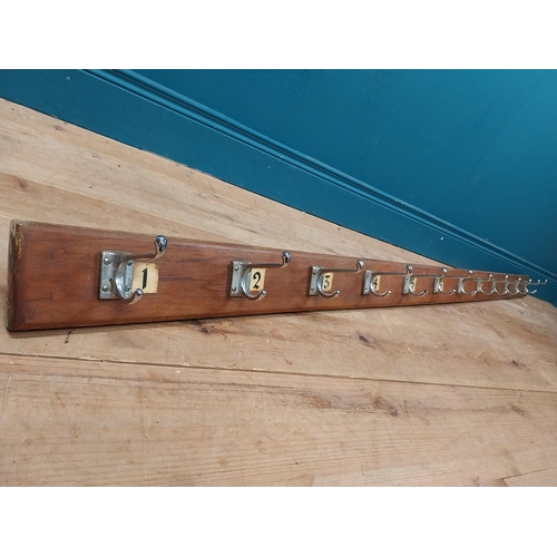 406 - Early 20th C. wooden wall mounted hat and coat rack with numbering 1 to 12. {14 cm H x 215 cm W x 11... 