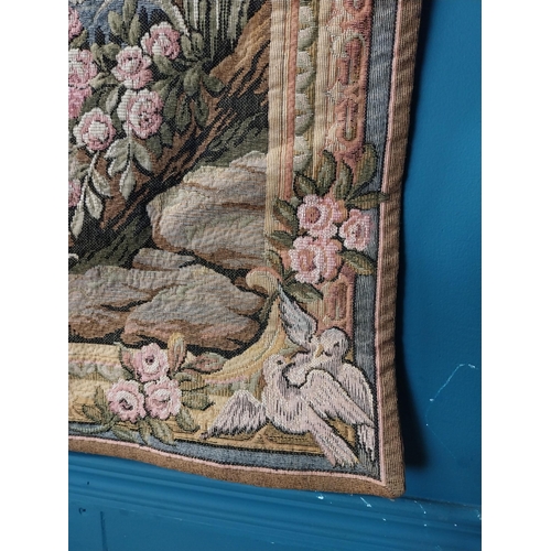 423 - Decorative tapestry depicting courting couple in garden with fountain. {96 cm H x 137 cm W}.