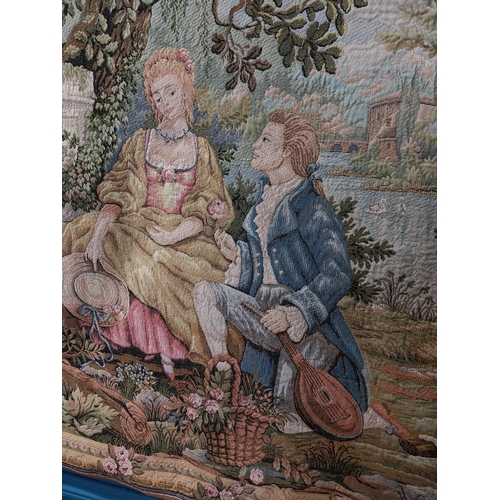 423 - Decorative tapestry depicting courting couple in garden with fountain. {96 cm H x 137 cm W}.