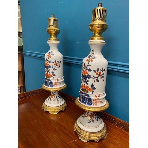 528 - Pair of decorative floral ceramic and gilded brass lamps. {60 cm H x 17 cm Dia.}