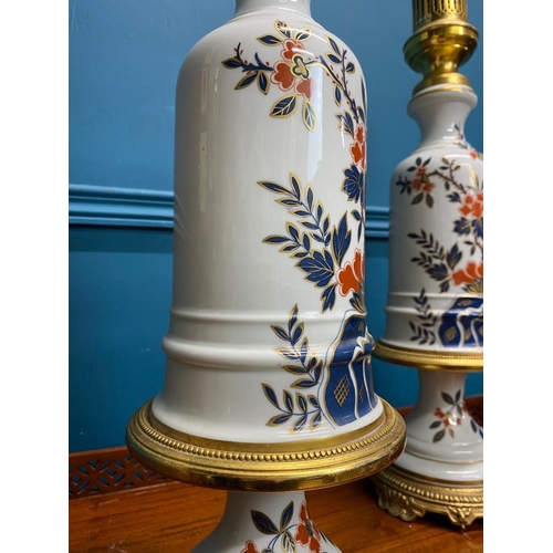 528 - Pair of decorative floral ceramic and gilded brass lamps. {60 cm H x 17 cm Dia.}