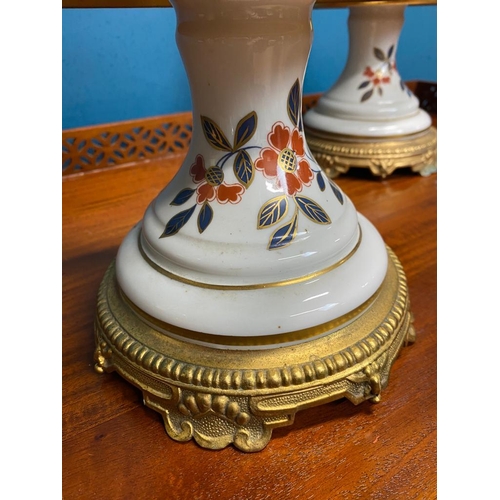 528 - Pair of decorative floral ceramic and gilded brass lamps. {60 cm H x 17 cm Dia.}