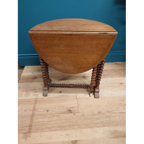 544 - Victorian oak oval drop leaf table in the Pembroke style. {53 cm H x 45 cm W x 70 cm D}.