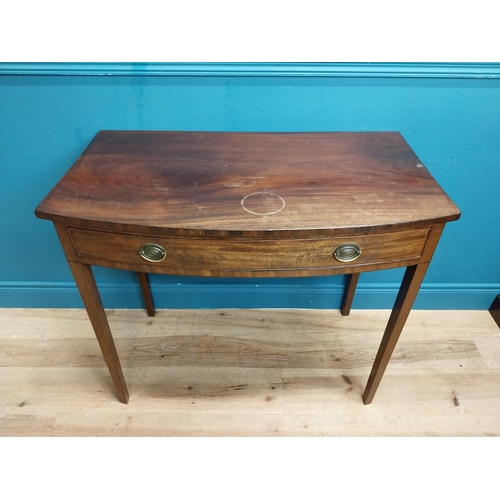 566 - Irish Georgian mahogany bow front side table with single drawer in frieze raised on tapered legs. {8... 