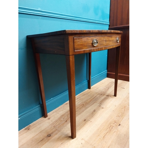 566 - Irish Georgian mahogany bow front side table with single drawer in frieze raised on tapered legs. {8... 