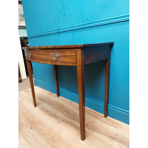 566 - Irish Georgian mahogany bow front side table with single drawer in frieze raised on tapered legs. {8... 