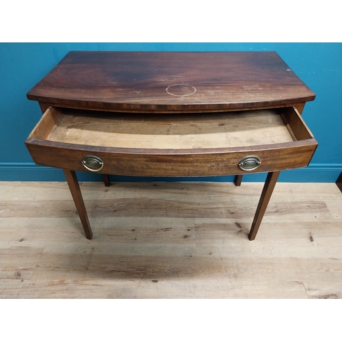 566 - Irish Georgian mahogany bow front side table with single drawer in frieze raised on tapered legs. {8... 