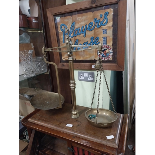 570 - 19th C. brass shop scales on mahogany base. {61 cm H x 60 cm W x 30 cm D}.