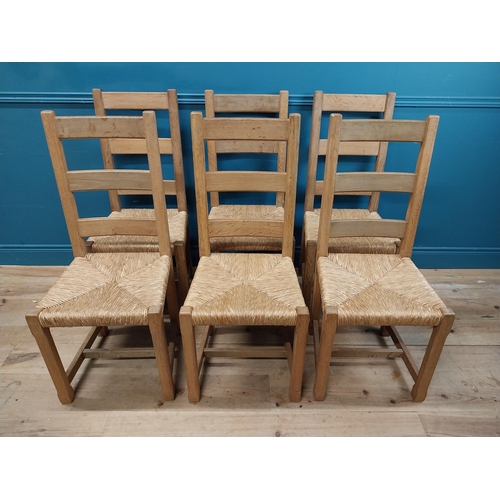 584 - Set of six oak kitchen chairs with rush seats. {104 cm H x 45 cm W x 45 cm D}.