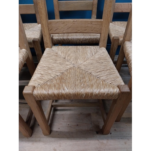 584 - Set of six oak kitchen chairs with rush seats. {104 cm H x 45 cm W x 45 cm D}.