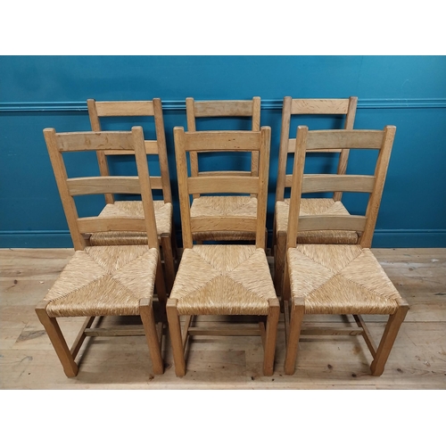 584 - Set of six oak kitchen chairs with rush seats. {104 cm H x 45 cm W x 45 cm D}.