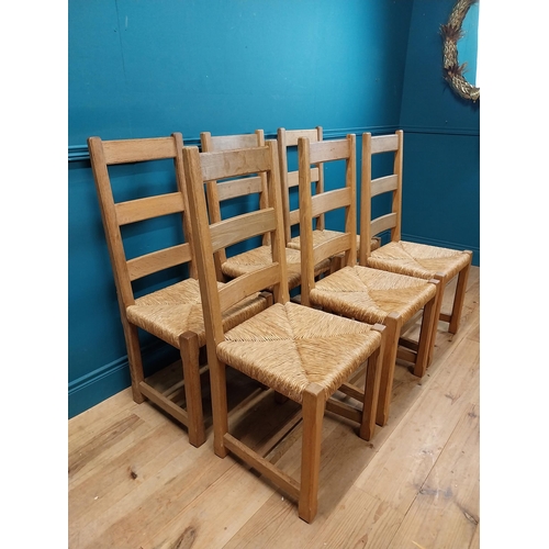 584 - Set of six oak kitchen chairs with rush seats. {104 cm H x 45 cm W x 45 cm D}.