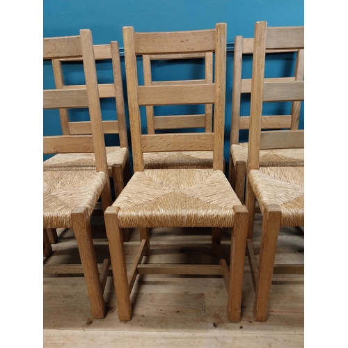 584 - Set of six oak kitchen chairs with rush seats. {104 cm H x 45 cm W x 45 cm D}.