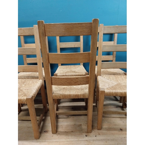 584 - Set of six oak kitchen chairs with rush seats. {104 cm H x 45 cm W x 45 cm D}.