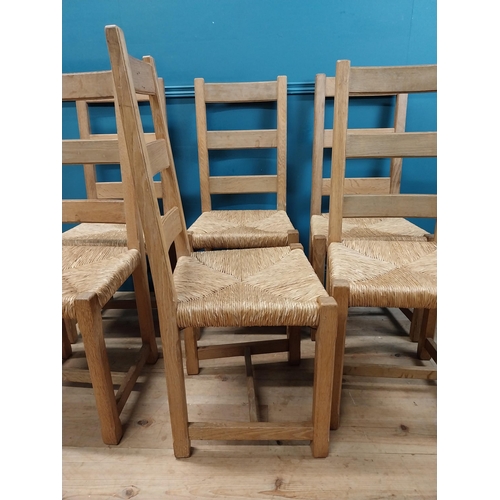 584 - Set of six oak kitchen chairs with rush seats. {104 cm H x 45 cm W x 45 cm D}.