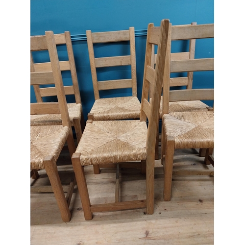 584 - Set of six oak kitchen chairs with rush seats. {104 cm H x 45 cm W x 45 cm D}.