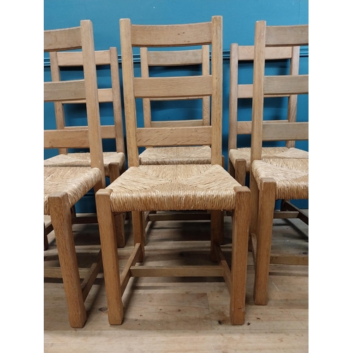 584 - Set of six oak kitchen chairs with rush seats. {104 cm H x 45 cm W x 45 cm D}.