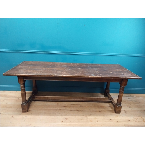 585 - Stained pine and oak kitchen table on four turned legs with single stretcher. {79 cm H x 220 cm W  x... 