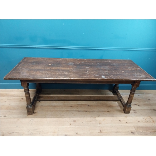 585 - Stained pine and oak kitchen table on four turned legs with single stretcher. {79 cm H x 220 cm W  x... 