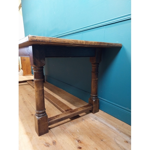 585 - Stained pine and oak kitchen table on four turned legs with single stretcher. {79 cm H x 220 cm W  x... 