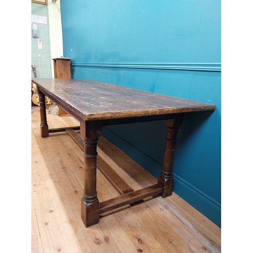 585 - Stained pine and oak kitchen table on four turned legs with single stretcher. {79 cm H x 220 cm W  x... 