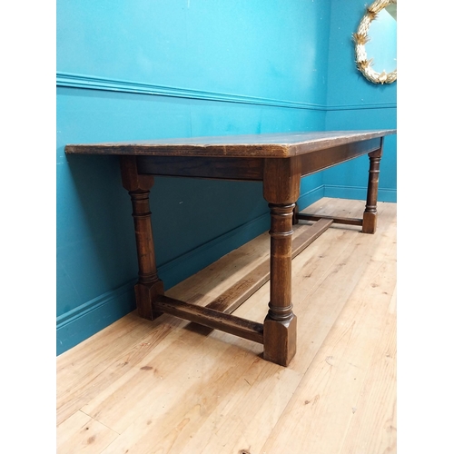 585 - Stained pine and oak kitchen table on four turned legs with single stretcher. {79 cm H x 220 cm W  x... 