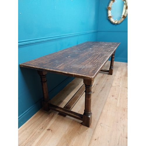 585 - Stained pine and oak kitchen table on four turned legs with single stretcher. {79 cm H x 220 cm W  x... 