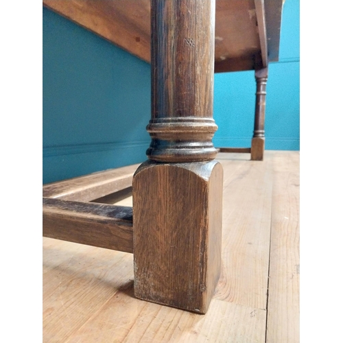 585 - Stained pine and oak kitchen table on four turned legs with single stretcher. {79 cm H x 220 cm W  x... 