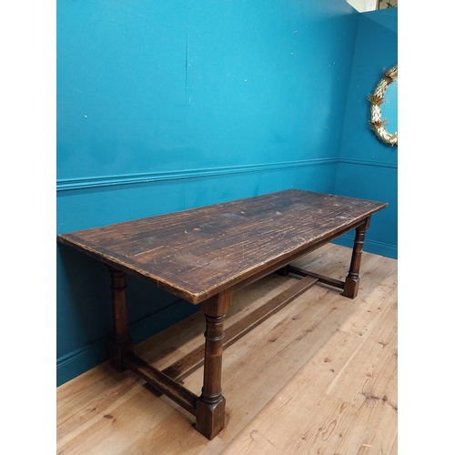 585 - Stained pine and oak kitchen table on four turned legs with single stretcher. {79 cm H x 220 cm W  x... 