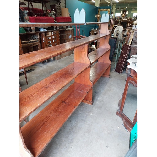 637 - Early 20th C. pitch pine open bookshelves {155 cm H x 270 cm W x 30 cm D}.