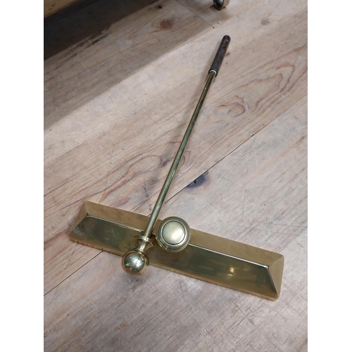 83 - Edwardian brass log carrier and poker. {27 cm H x 50 cm W x 37 cm D}.