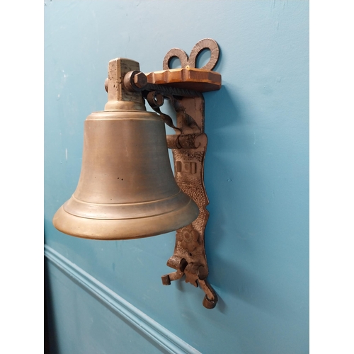 84 - Bronze wall bell with original bracket. {50 cm H x 24 cm W x 30 cm D}.