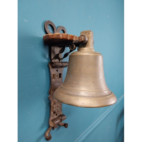 84 - Bronze wall bell with original bracket. {50 cm H x 24 cm W x 30 cm D}.