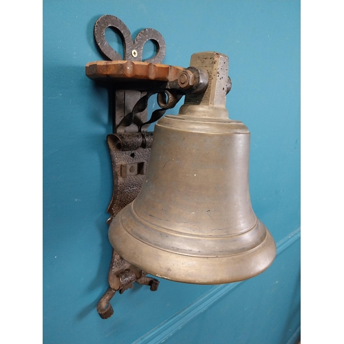 84 - Bronze wall bell with original bracket. {50 cm H x 24 cm W x 30 cm D}.