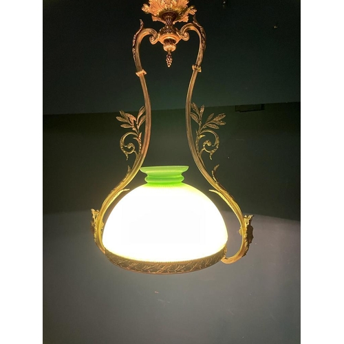 315 - Edwardian gilded brass hanging light fitting with green glass shade {}.