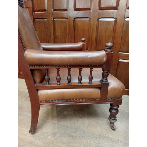 470 - Pair of oak fireside chairs with tan leather on turned front legs with castors {H 105cm x W 66cm x D... 