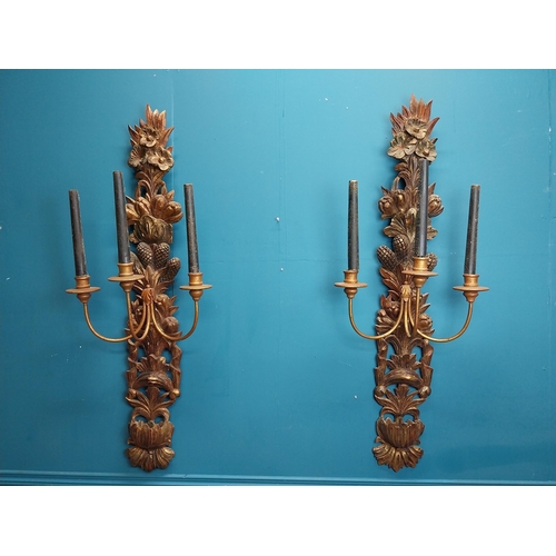 608 - Pair of good quality giltwood wall lights decorated with foliage. {122 cm H x 45 cm W x 30 cm D}.