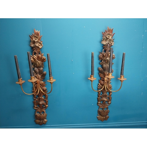 608 - Pair of good quality giltwood wall lights decorated with foliage. {122 cm H x 45 cm W x 30 cm D}.