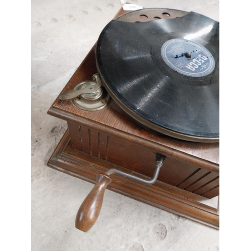 702 - Early 20th C. oak cased gramophone with painted metal horn {67 cm H x 63 cm  W x 53 cm D}.