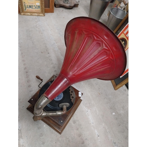 702 - Early 20th C. oak cased gramophone with painted metal horn {67 cm H x 63 cm  W x 53 cm D}.