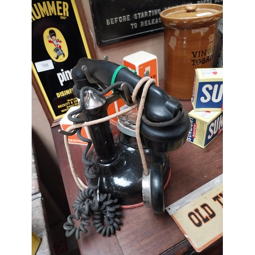 625 - 1930's Bakelite and metal telephone. {24 cm H x 23 cm W x 13 cm D}.