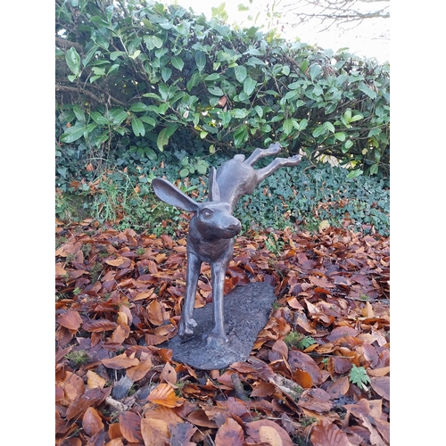 751 - Exceptional quality bronze sculpture of a leaping hare {58cm H x 100cm W x 30cm D}