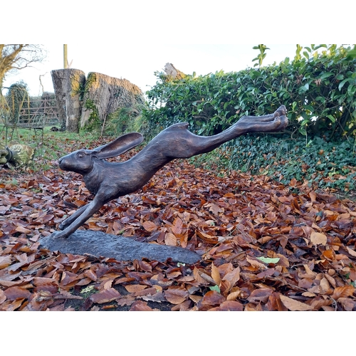 751 - Exceptional quality bronze sculpture of a leaping hare {58cm H x 100cm W x 30cm D}