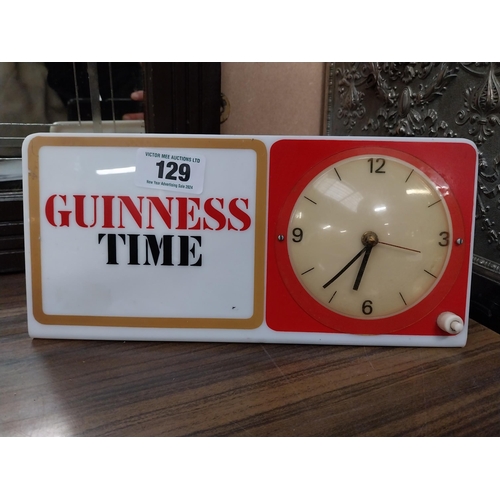 129 - Guinness Time Perspex battery operated advertising clock. {15 cm H x 30 cm W}.