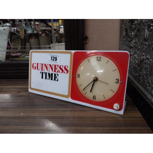 129 - Guinness Time Perspex battery operated advertising clock. {15 cm H x 30 cm W}.