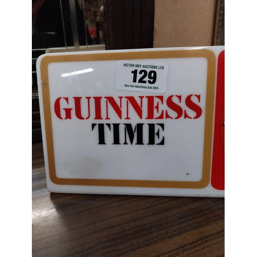 129 - Guinness Time Perspex battery operated advertising clock. {15 cm H x 30 cm W}.