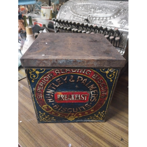 180 - Huntley and Palmers Biscuit lidded advertising tin. {34 cm H x 34 cm W x 34 cm D}.